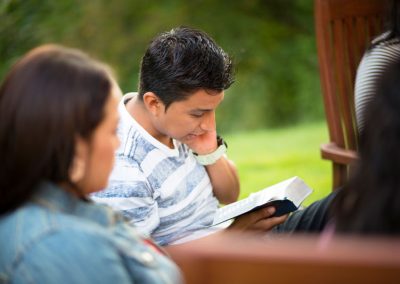 family reading scriptures outside